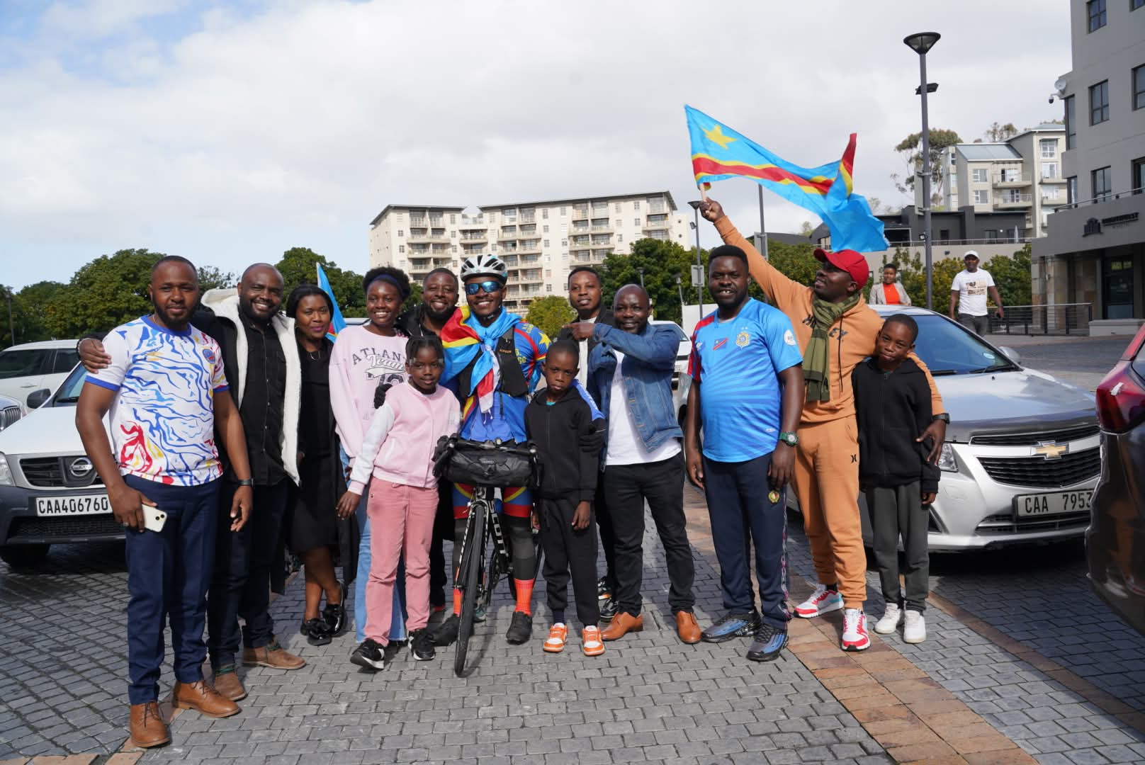 Community members welcoming a cyclist