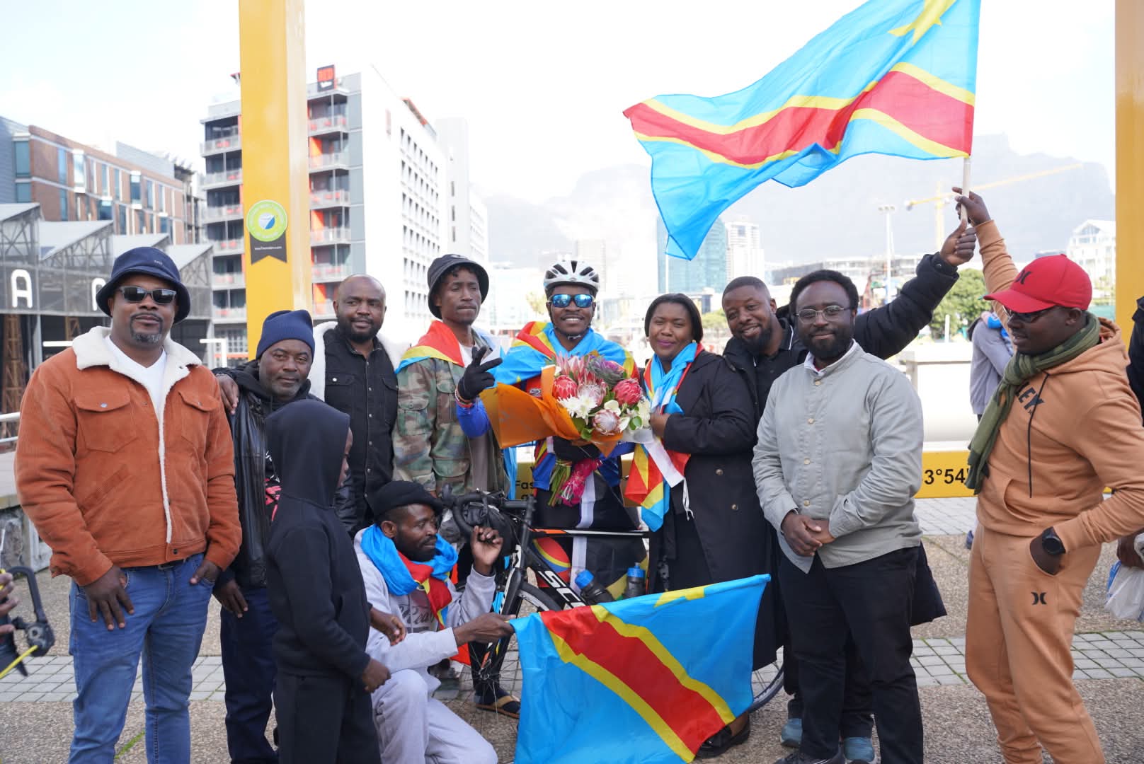 Community members celebrating with DRC flags in Cape Town